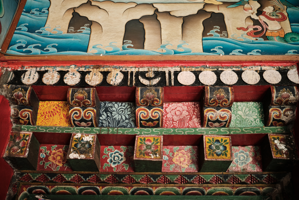 Carved wooden columns of a doorway painted in floral motifs at Enchey gompa, Gangtok.