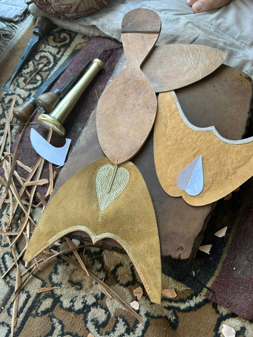 A paper stencil placed alongside its embroidered translation on leather, showing how a delicate cut motif is transformed into tilla work by the women of the household. (Picture Credits: Nandini Agarwal)