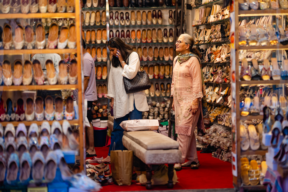 An extensive display of machine-made juttis in Patiala, stacked tightly across shelves, showcasing a wide range of colours, embellishments, and surface treatments. (Picture Credits: Nandini Agarwal)