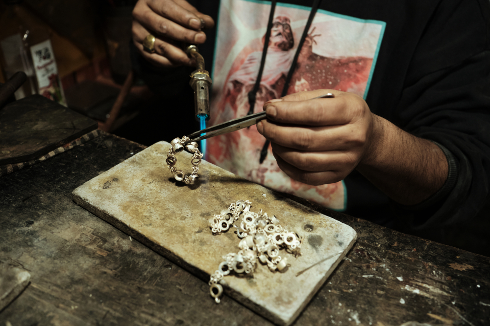 Firing and linking together silver chains at the shop. (Picture Credits: Abhishek Anil)