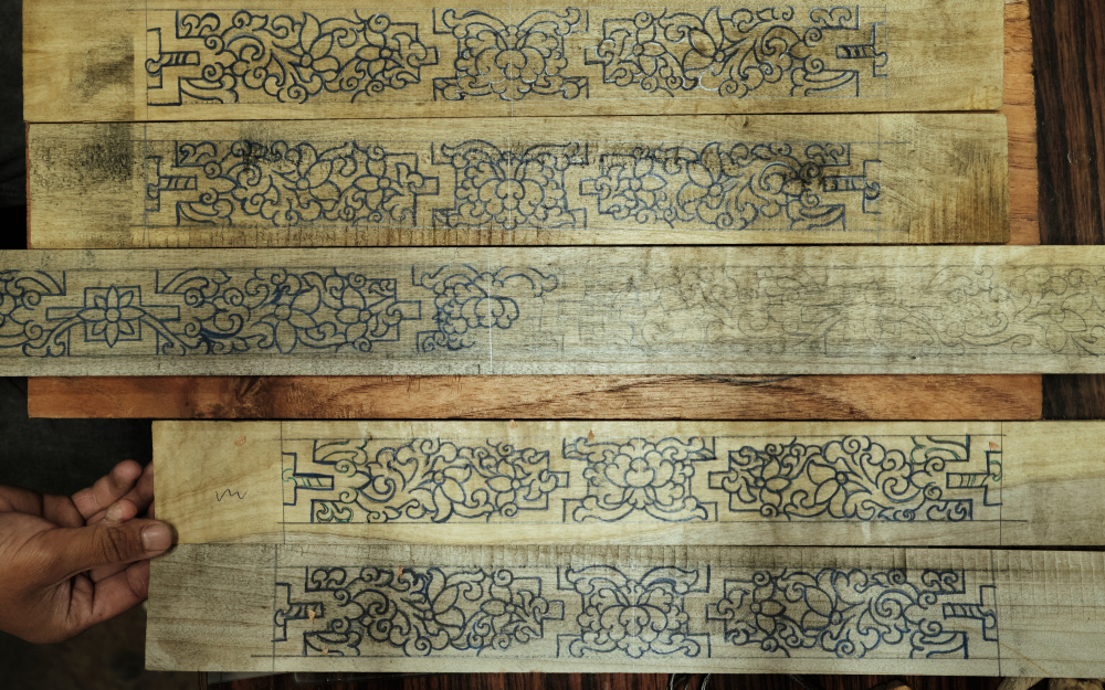 Hand drawings over wooden panels for Choktse table, ready to be carved at DHH, Gangtok. (Picture Credits: Abhishek Anil)
