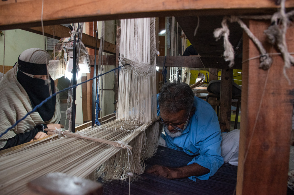 Weaver setting up weft and warp threads on the loom. (Picture Credits: Anil Purohit)