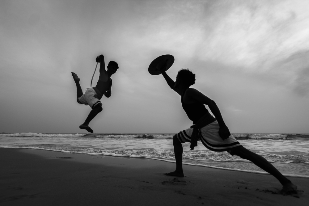 Kalaripayattu warriors practising on the beach.