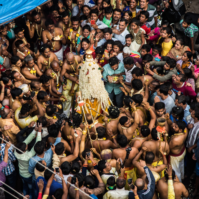 The Karaga priest protected by the veerakumaras while devotees try to seek blessings during the procession (Courtesy: PEEVEE)