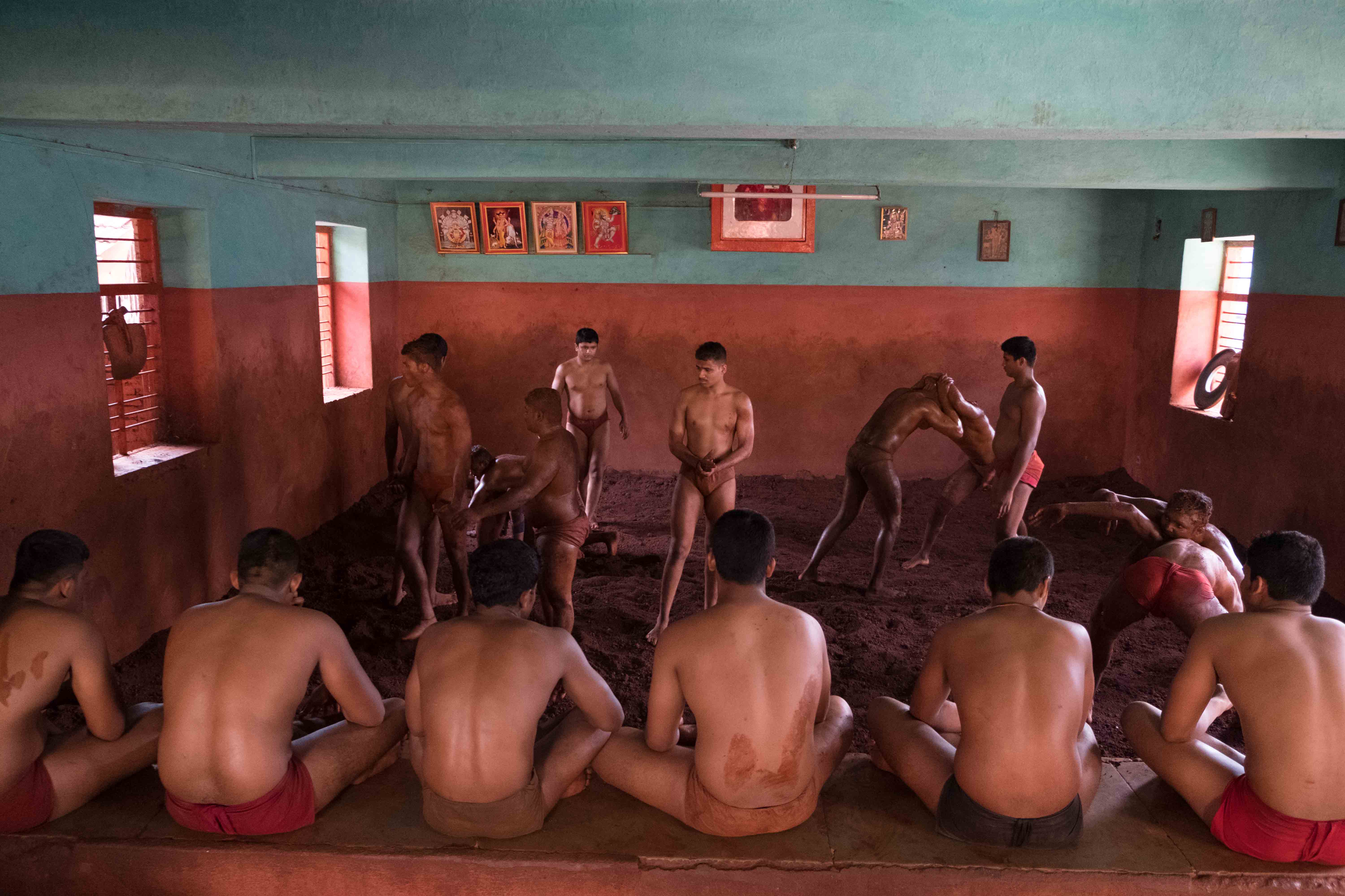 Young wrestlers practising wrestling in Shaupuri Akhada in Kolhapur. Because of limited space in the arena, a hierarchy is followed. Junior wrestlers usually get space after senior members complete their practice. Photograph by Indrajit Khambe ©Sahapedia