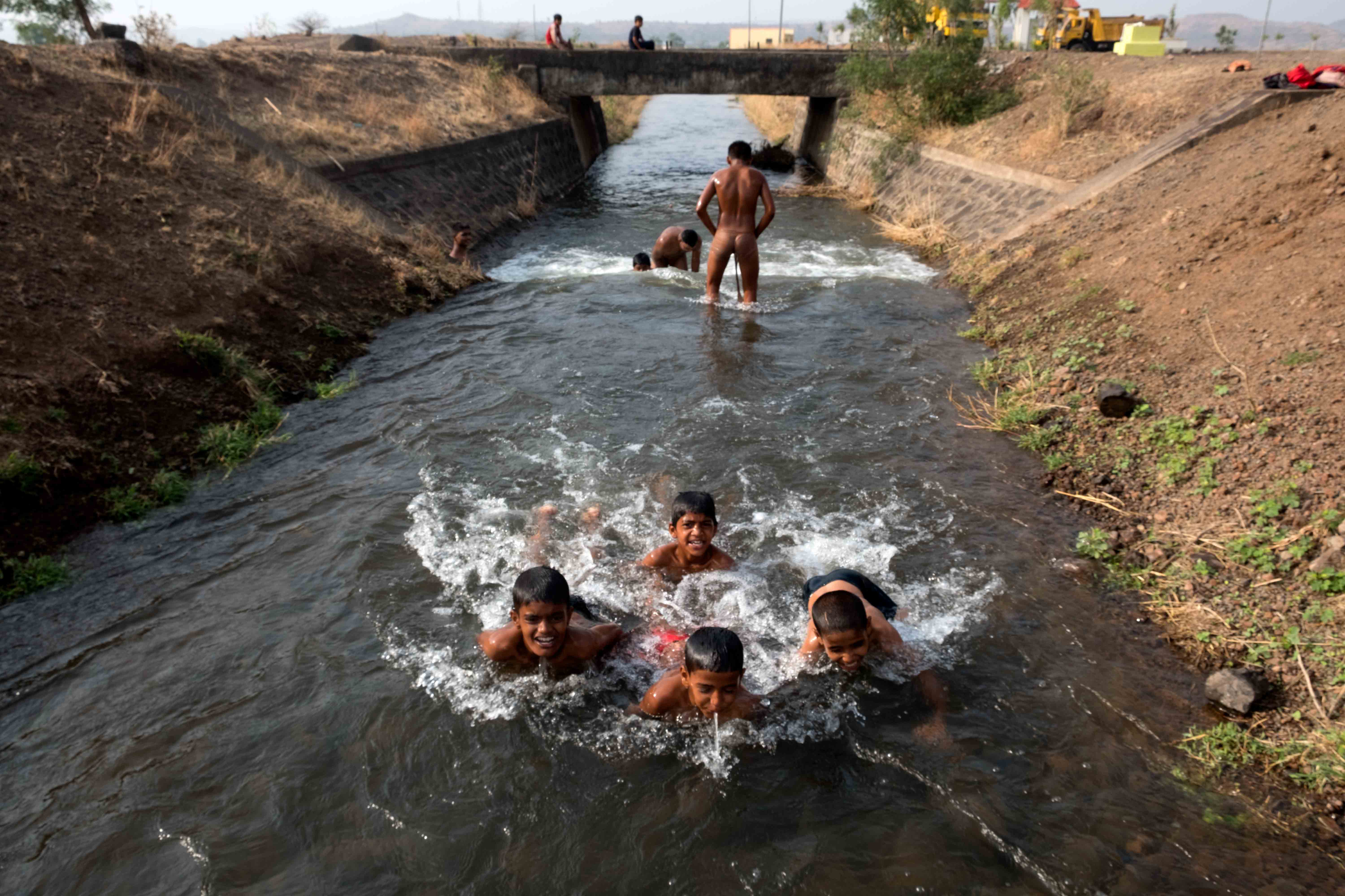 Young wrestlers taking bath in a canal after their morning practice session in Surli village of Satara district. Though much of the training takes place indoors, outdoor training also forms an important part of the daily routine which includes a range of stamina-building exercises like swimming, running and climbing. Photograph by Indrajit Khambe ©Sahapedia 