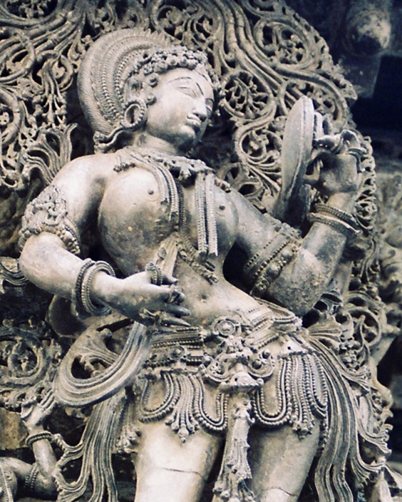 Fig. 2. Madanika with mirror, thirteenth-century Hoysala sculpture, temple at Belur, Karnataka (Courtesy: Sharada Srinivasan)