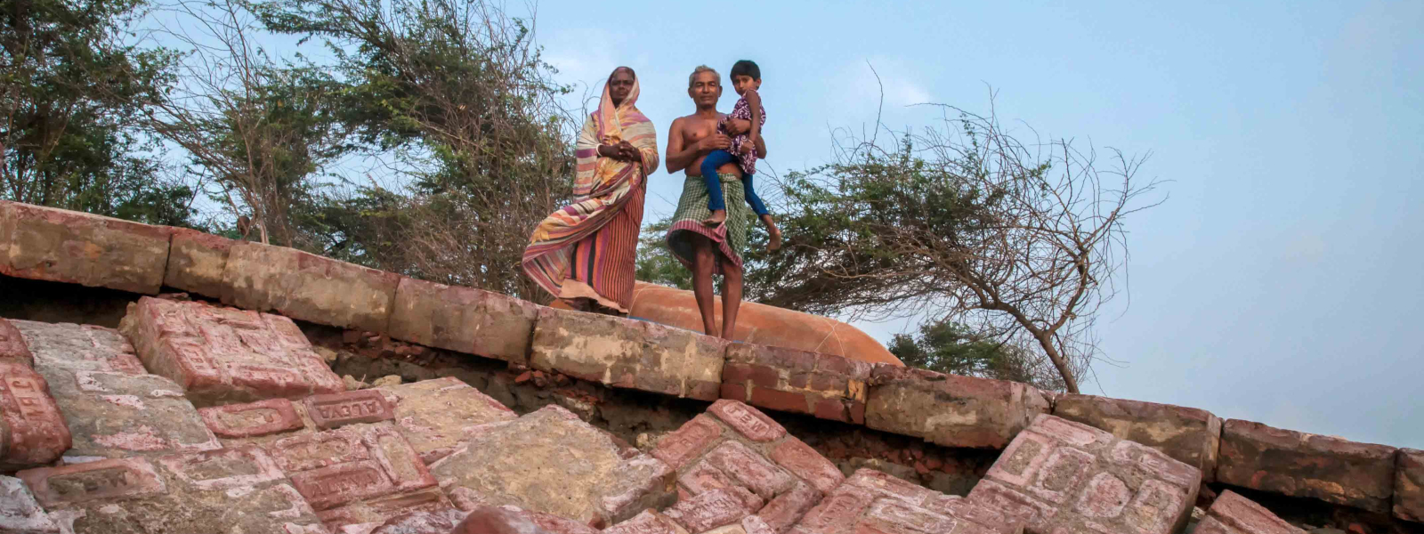 Paran Maiti and his wife, residents of Gobardhanpur village, stand on a destroyed concrete embankment on the southern part of G-Plot Island. The saline water is highly corrosive and even a concrete dam is not able to provide lasting security.