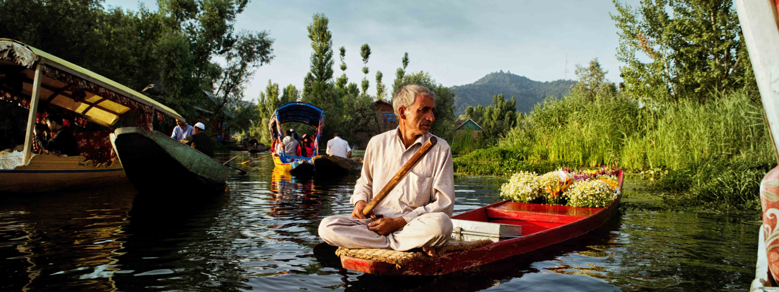 Farmers gather at the floating market with their boats laden with vegetables, flowers and fruits. They call out to the buyers in local Kashmiri dialect. The vegetables and flowers they sell are grown in large floating farms on the lake itself and also in the catchment area surrounding the waterbodies.