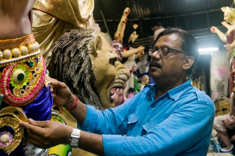 Mintu Pal fixing the costumes on his clay idols prior to delivery (Courtesy: Aaheli Sen)