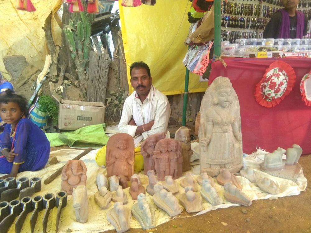 A vendor selling stone sculptures in market
