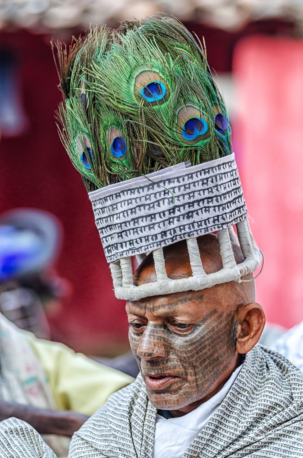 a Ramnami Man with Peacock Head-Dress and Ramram Tattoo over his Face.