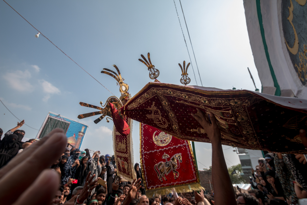 Fig. 5: An alam being taken out of an imambada to join the eighth Muharram procession at Nasirabad in Raebareli