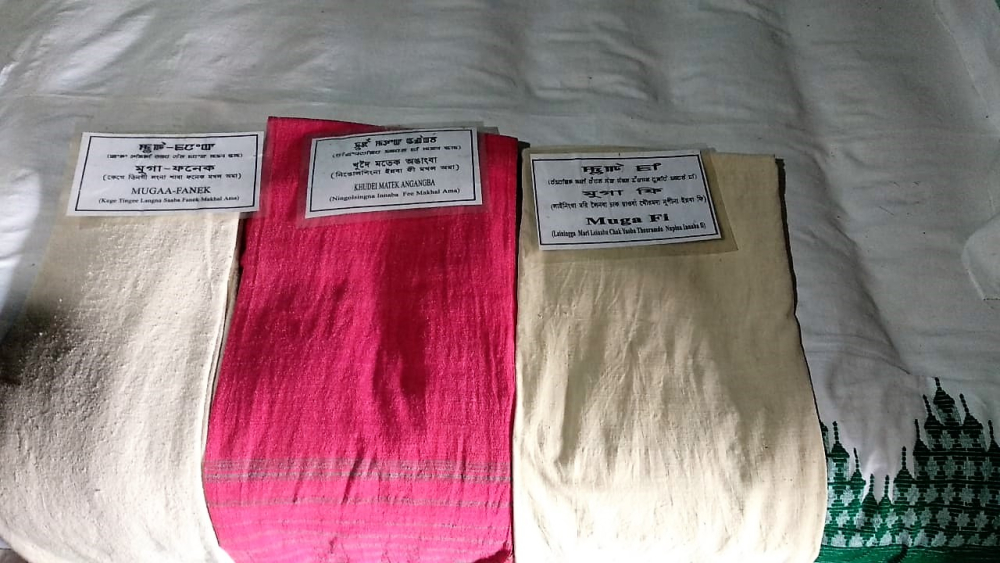 Fig. 2: A display curating traditional attire of women in ancient Meitei society at MMRC & Unity Park, Khangabok: (from left) muga phanek (phanek made with muga silk), khudei matek (shawl for daily use) and muga fi (shawl for rituals) (Courtesy: Masaco Ningthoujam)