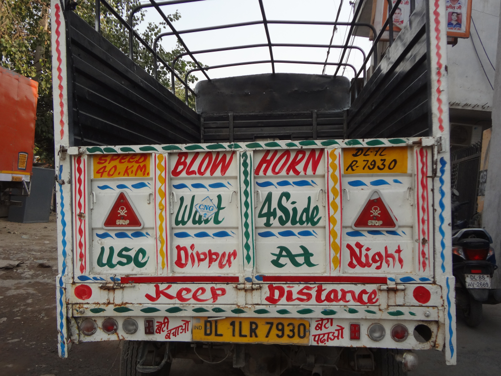 Fig. 3: Truck literature has diversified into various other forms of transport. This pickup truck parked at Delhi's Sanjay Gandhi Transport Nagar carries writings three different phrases that appear commonly on trucks, ‘Use dipper at night’, ‘Keep distance’, and ‘Wait for side’. 