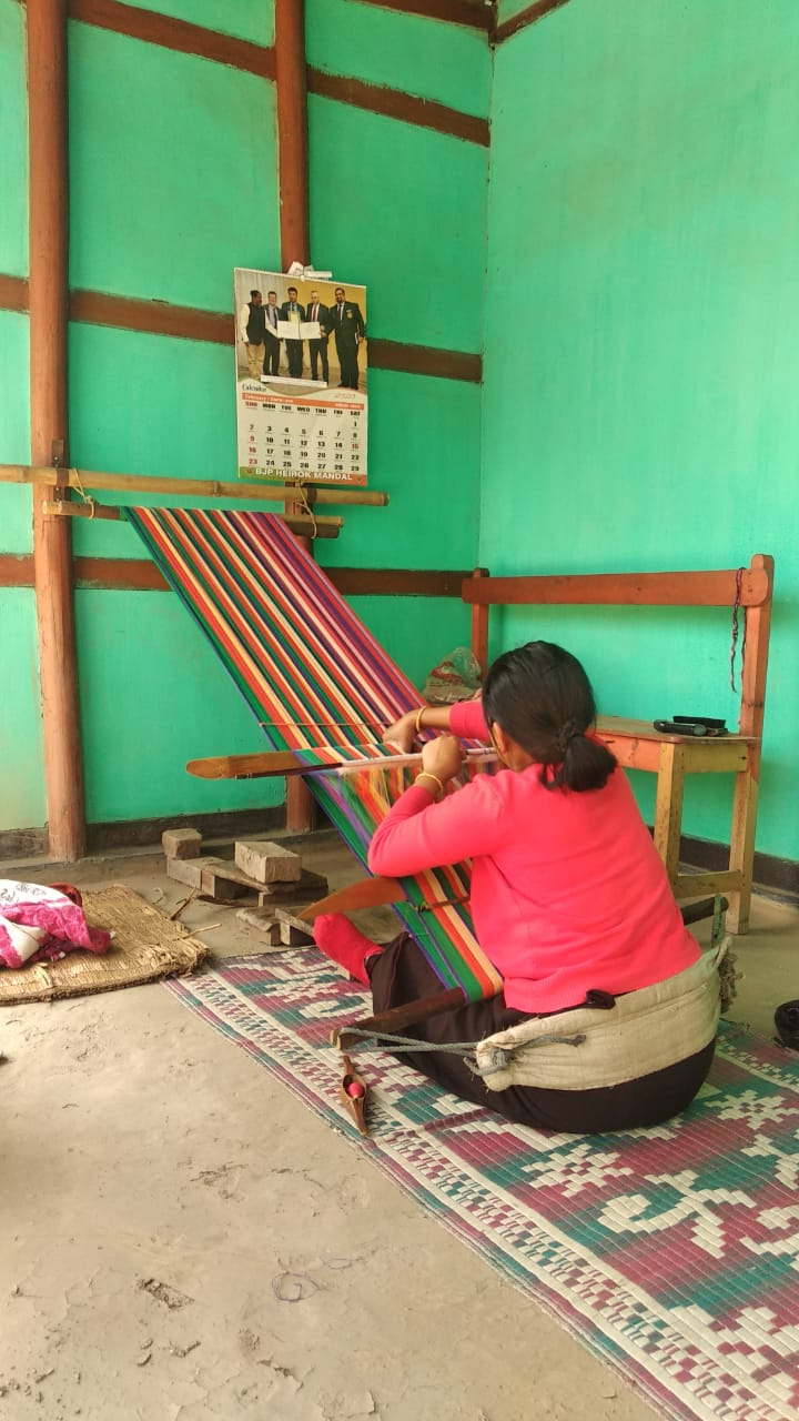 Fig 4: The khwang loom has traditionally been used to make all phanek mayek naibi as well as other shawls. Two halves of the phanek are woven with silk or cotton borders on the top and bottom and stitched together in the middle 