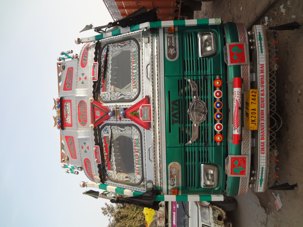 Fig. 4: Trucks registered in Jammu and Kashmir are distinctly visible owing to their bright colours and slanted cab roofs. This is a J&K truck parked in Sanjay Gandhi Transport Nagar 