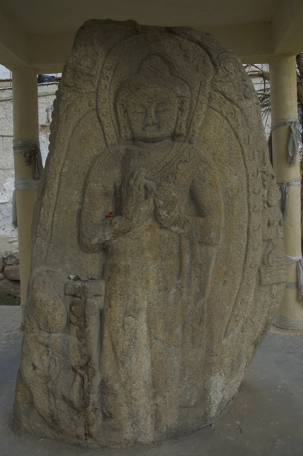 Fig. 6: Changspa has reliefs of Maitreya Buddha and Avalokitesvara on the reverse sides of a stone in the midst of the old settlement area (Courtesy: Tashi Morup, 2004)