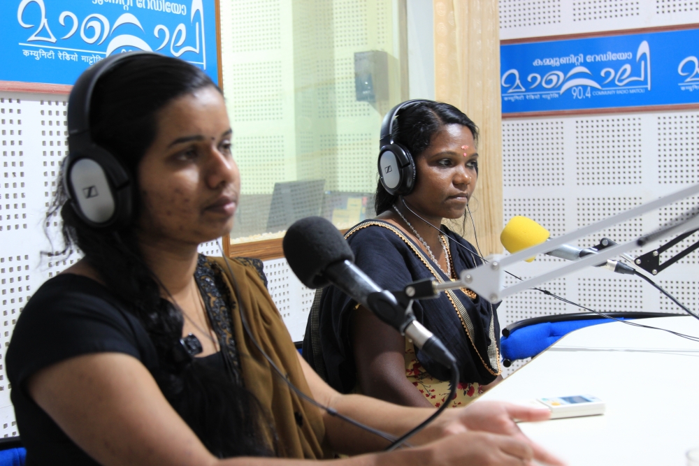 Fig. 5.  Yashodha, a singer from the local community in Mananthavady, goes on air with Bhagyalakshmi, the programme producer for the live phone-in show, Sallapam on Radio Mattoli. Nineteen per cent of Kerala’s adivasi communities live in Wayanad where the community radio station is located.  Most of the station’s producers are from local adivasi communities and the station broadcasts content in the local adivasi languages along with Malayalam (Courtesy: Radio Mattoli)