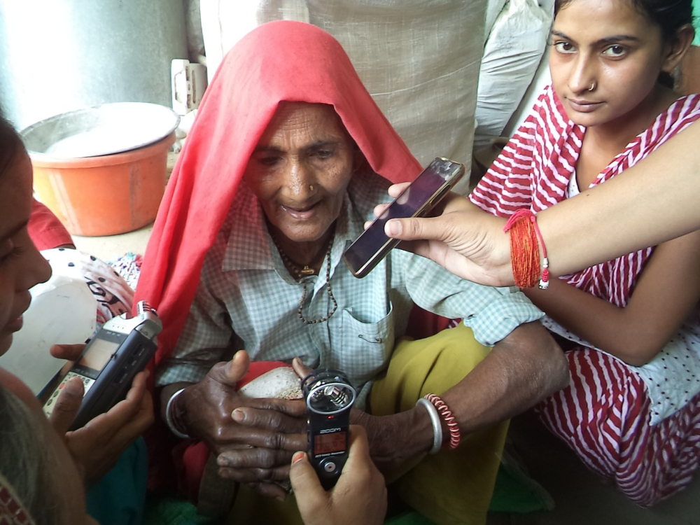 Fig. 6. Hemlata, a reporter with the radio station, Alfaz e Mewat records a community member from Bhadas, a village in the radio station’s catchment area for the show, Sehat ka Paigam, discussing traditional food patterns in the region (Courtesy: Alfaz-e-Mewat)