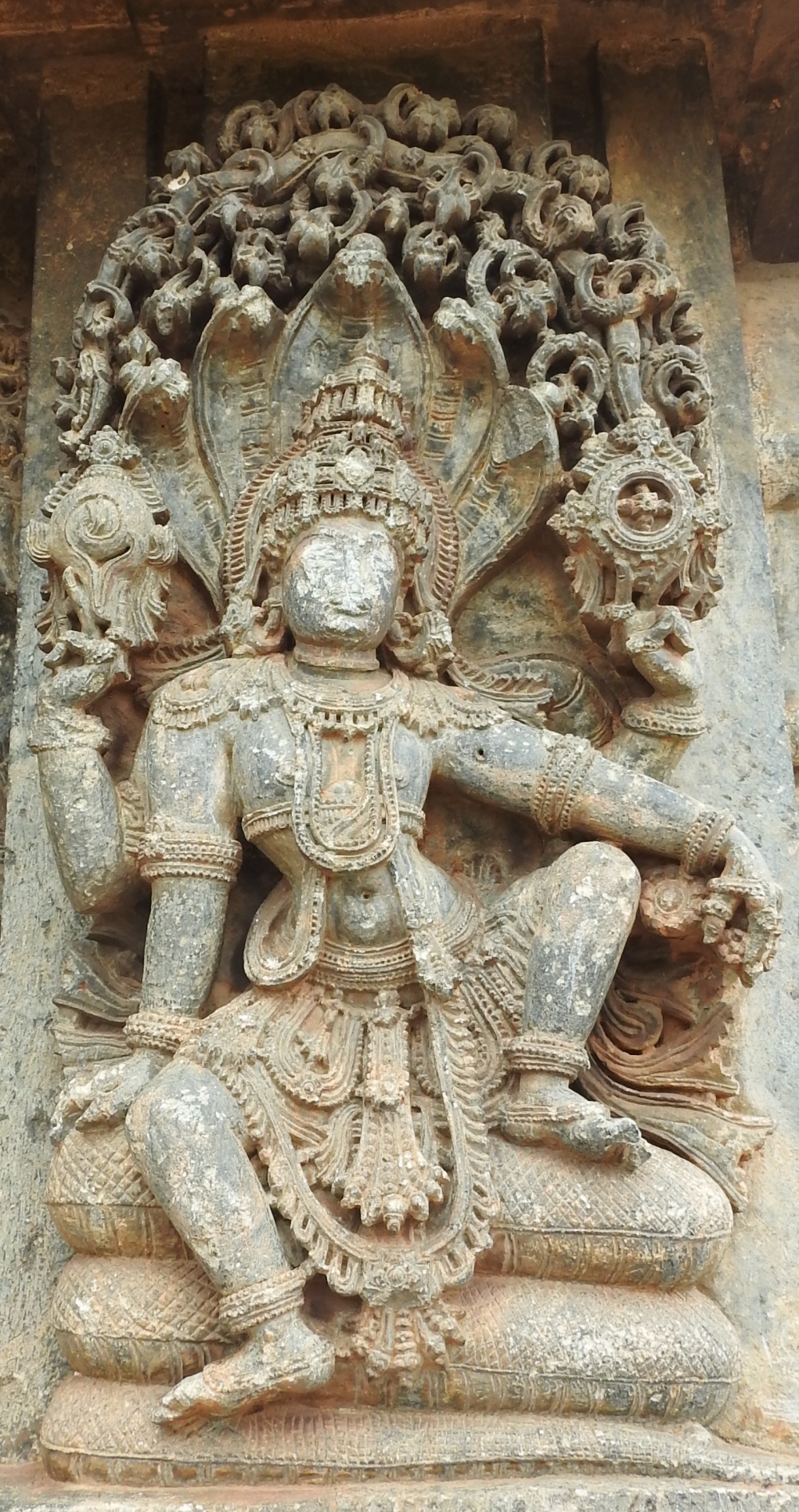 Fig. 10: The image of Adimurti or Para-Vasudeva (the transcendental being who controls the universe) seated on the coils of the serpent Ananta is displayed on the jangha. Para-Vasudeva holds conch and discus in his upper two hands, and the five hoods of Ananta serve as a parasol