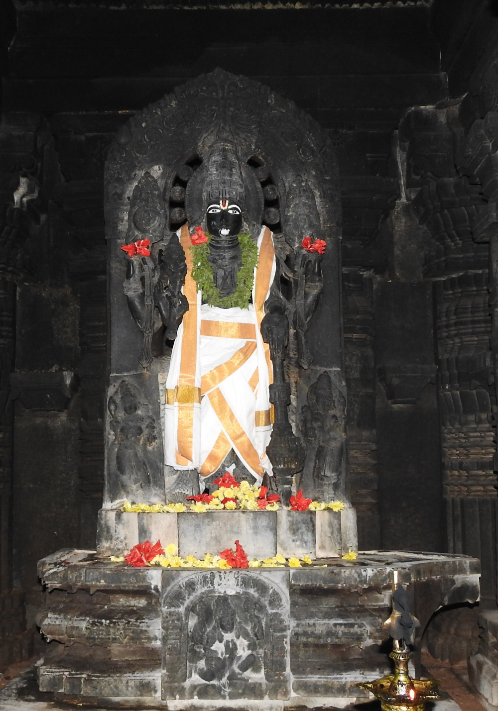 Fig. 1: The image of Keshava from the central garbhagriha (sanctum sanctorum) with Sridevi and Bhudevi flanking him near his feet. His attributes include conch, discus, mace, and lotus. Garuda in anjalimudra (hand pose suggesting submission or prayer) is carved on the pedestal.