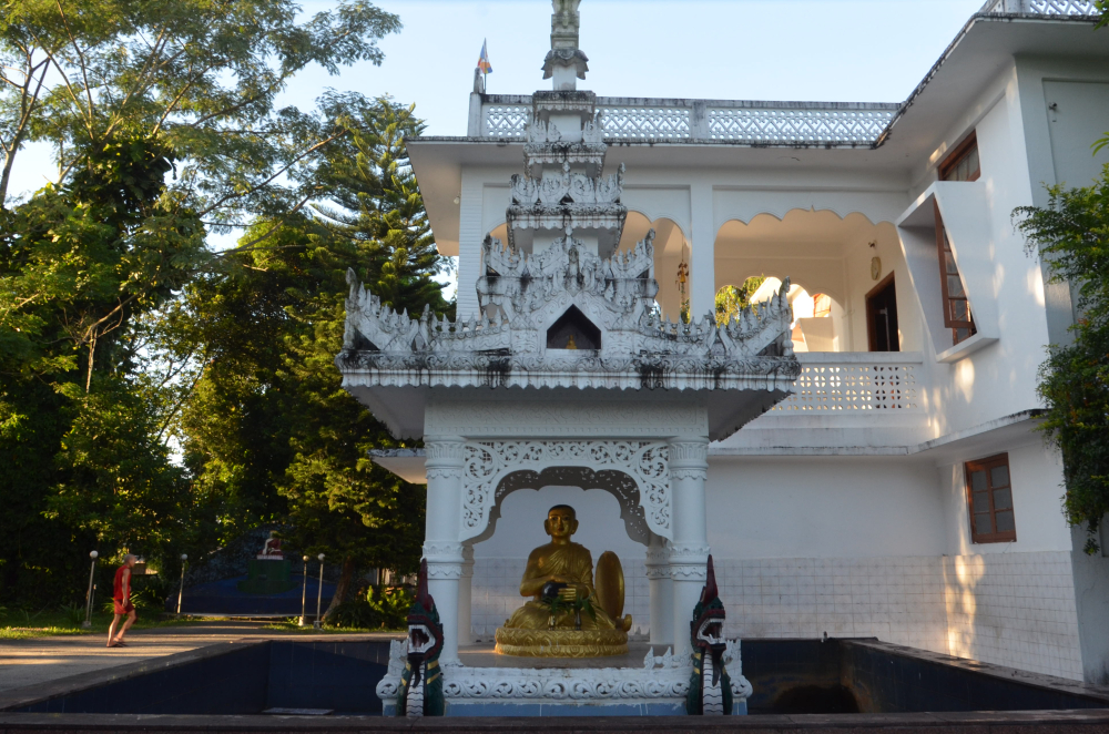 Fig. 5: A large sculpture of Upagupta, surrounded by an artificial pond in Pariyatti Sasana Buddha Vihar, Namsai, Arunachal Pradesh. According to legends associated with him, he is still alive under water, waiting for the future Buddha. Large sculptures of Upagupta are placed inside shrines which are decorated with ornamental motifs and mythical creatures