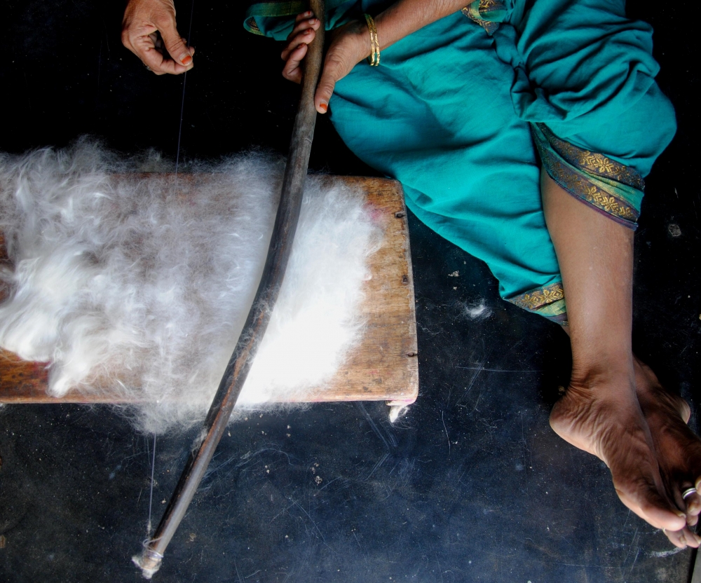 Carding with carding bow. The vibrations from the plucked string of the carding bow make the cotton fibres open into an airy mass (Courtesy: Samyuktha Gorrepati)