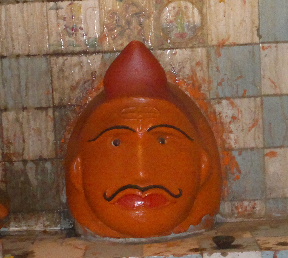 Fig. 3: Prior to the performance, maach artistes visit the Bhairavnath temple to perform a prayer, seek blessings and pay their respects for a successful performance. The first invitation of the performance is presented to Lord Bhairavnath (Courtesy: Mitali Trivedi)