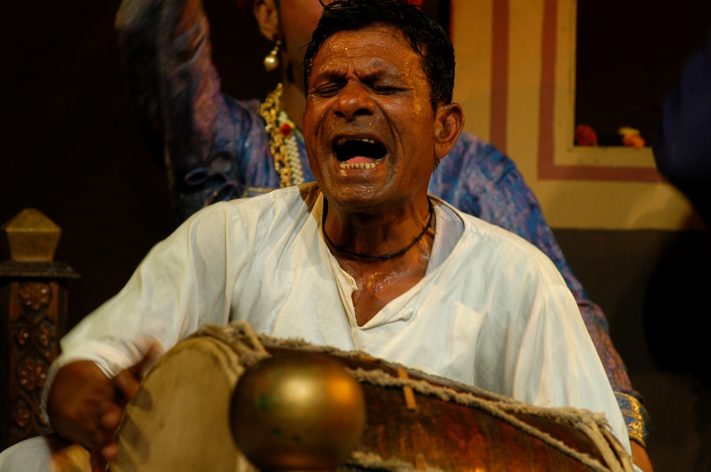 Fig 4. The key percussionist plays the dholak with same enthusiasm the whole night. It is essential for the percussionist to master the varied rhythms of maach as he is responsible to keep the rhythm of the performance flowing till dawn (Courtesy: Mitali Trivedi)
