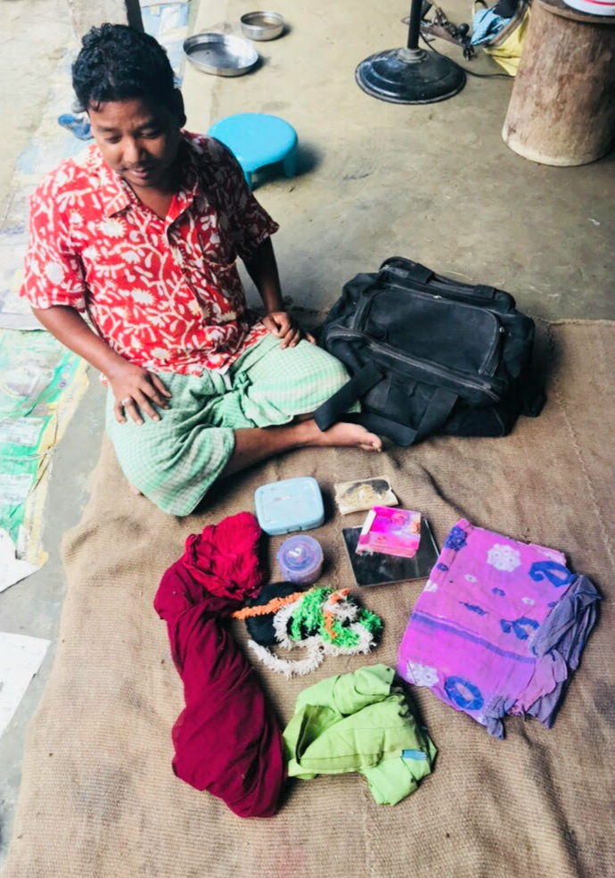 Fig. 8: Saral Sarkar from Ushabhanu Natyo Dol, who often plays female characters, is seen here with his make-up kit and attire which include vermillion powder, false hair, and a saree.