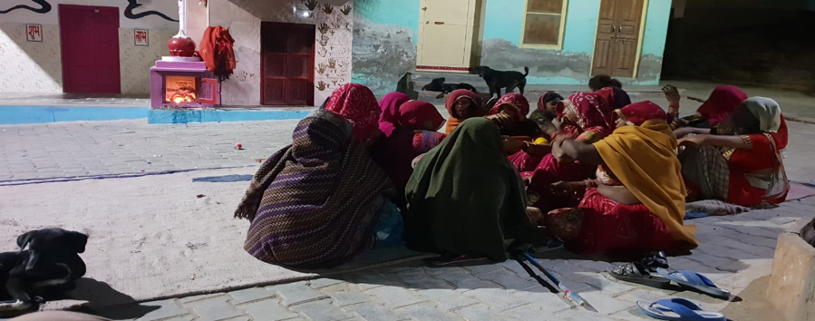 Fig. 4: Women congregate in a Meghwal mohalla for a ratijoga on the last day of Navratri in Ratangarh. Seen in the background is a shrine to Gogaji and an accompanying shrine to Mataji (Courtesy: Vishes Kothari)