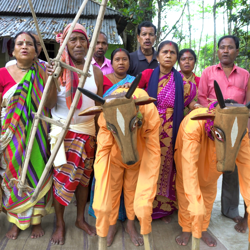 Seen in this picture are the members of the trailblazing women-led khon group, Mohisbathan Narikolyan Samiti, helmed by Akulbala Sarkar, before enactment of the popular drama, Halua Haluani. Presence of props like plough and cow masks add palpability to the tragic representation of a rural household (Courtesy: Shreyosee Sen)