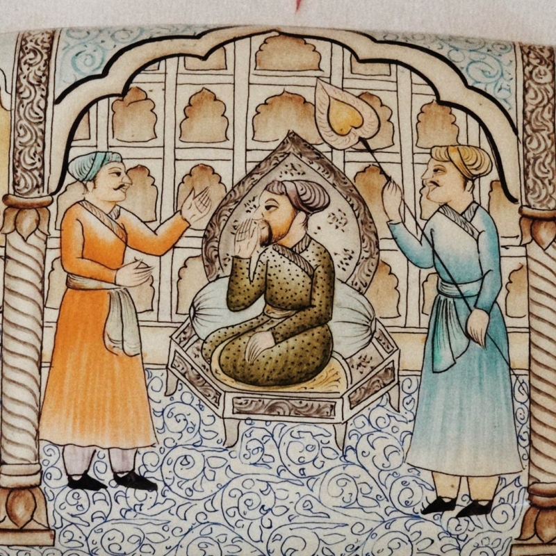 A papier mache box depicting a scene from a Mughal court with the emperor on his throne.  He seems to be engaged in court matters, while dignitaries and servants admire him in humble submission (Courtesy: Sadaf Nazir Wani)
