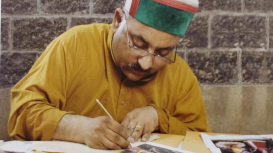 Dr Vijay Sharma, a senior artist at the Bhuri Singh Museum, Chamba, working on a miniature painting (Courtesy: Dr Vijay Sharma)